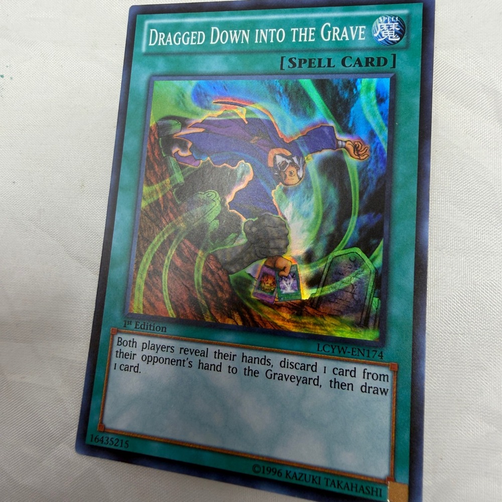Yu-Gi-Oh Dragged Down Into The Grave 1st Edition Super Rare LCYW-EN174 Spell